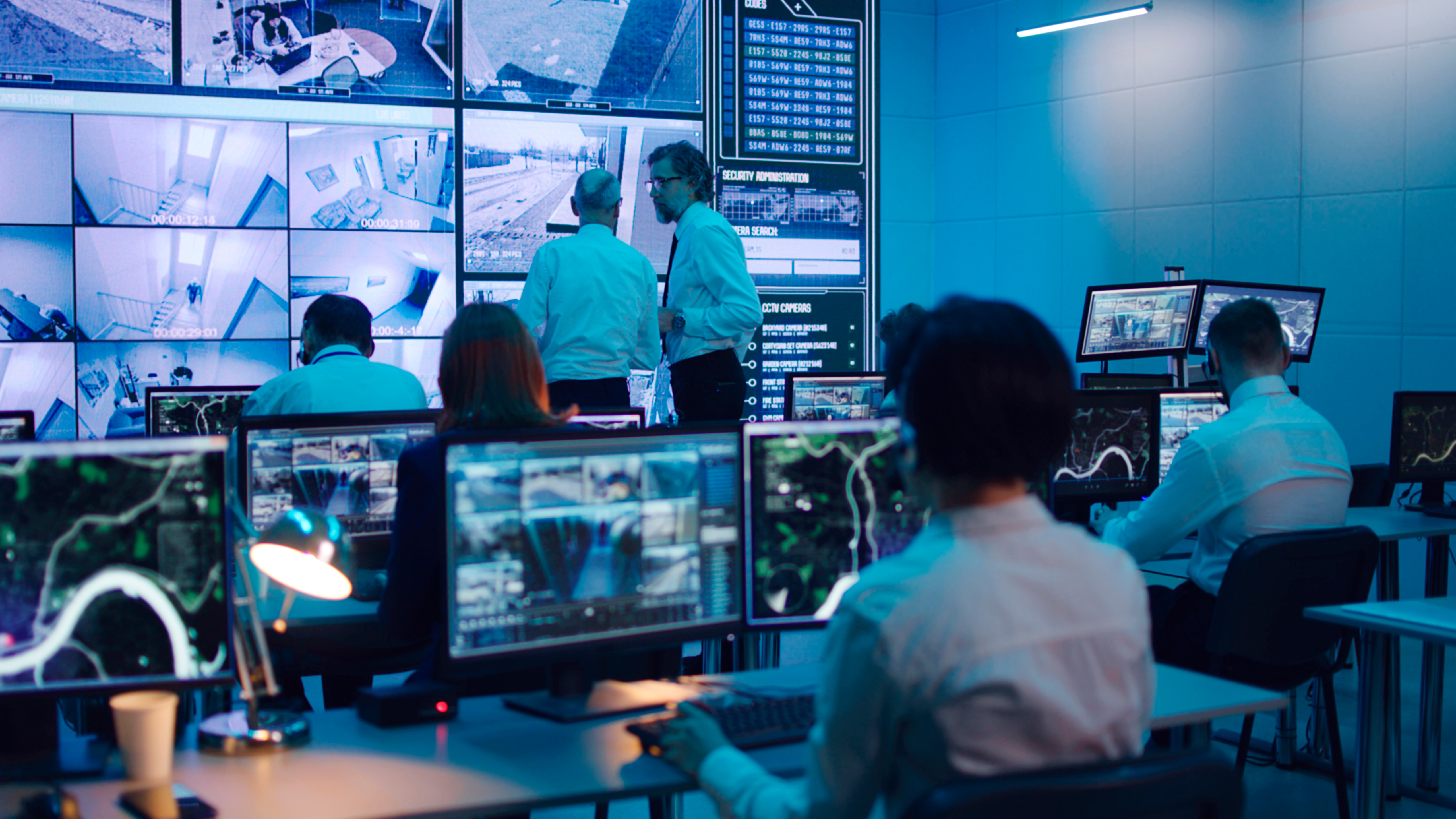 People working in a data surveillance room
