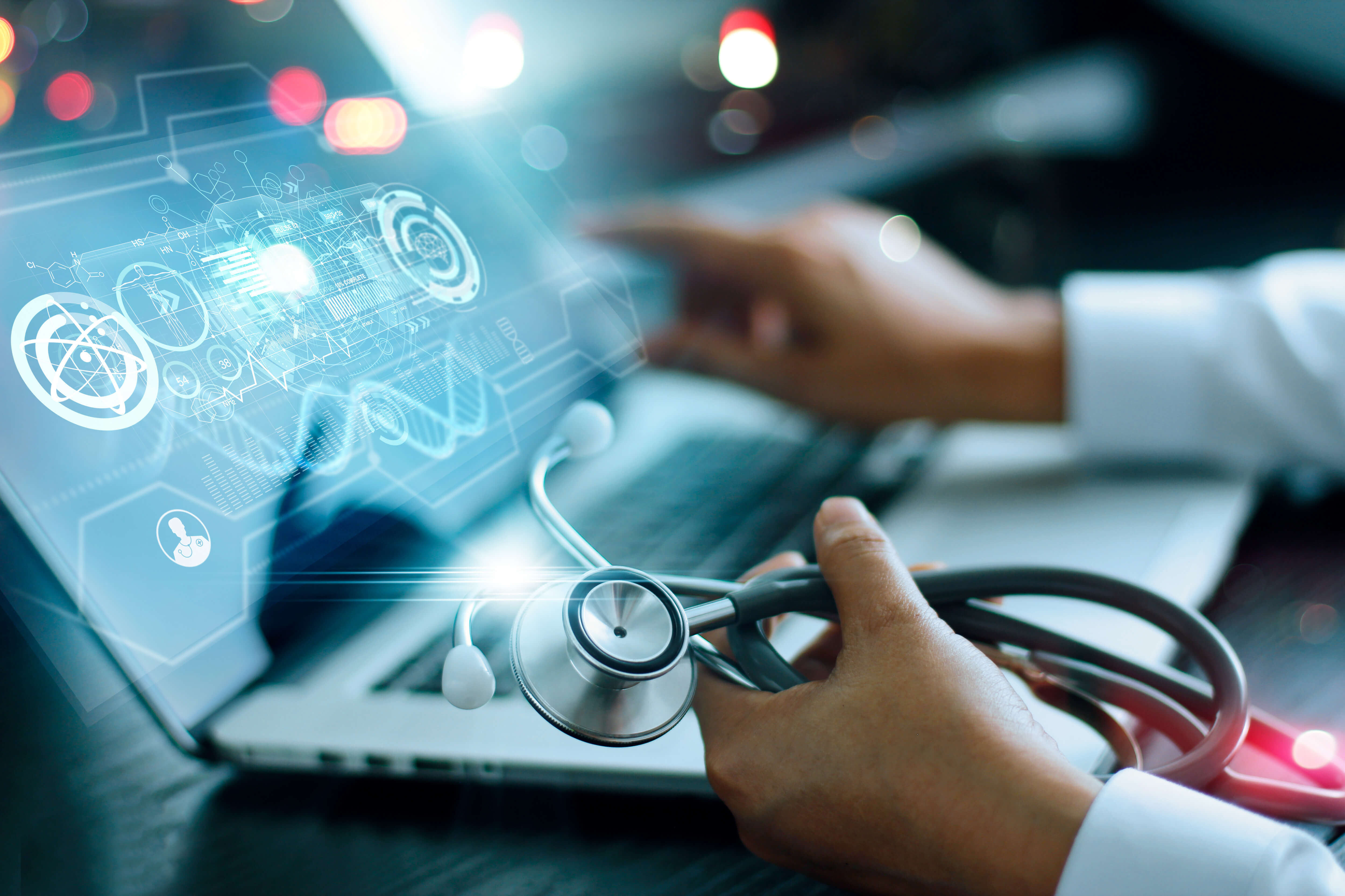 Laptop with stethoscope and technology overlay