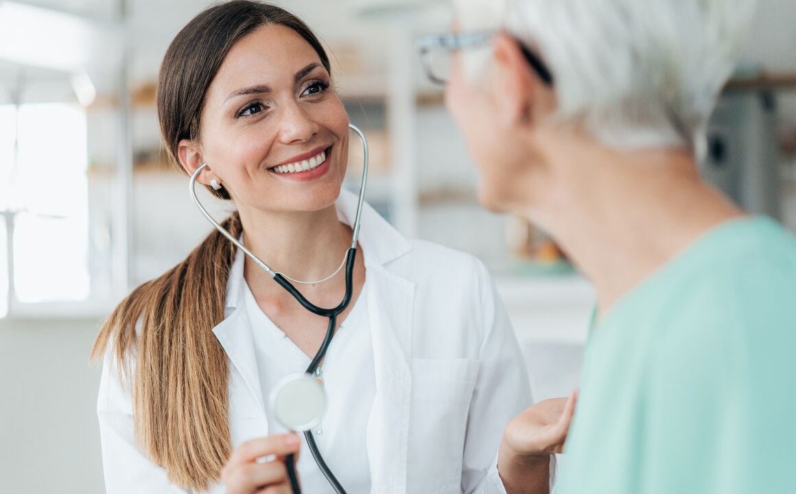 Female Medicaid provider wearing stethoscope examines a patient
