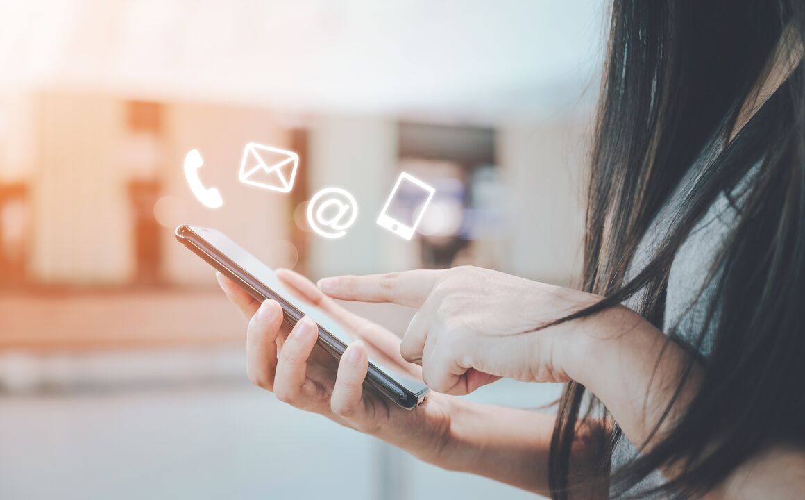 A woman holding her mobile device.