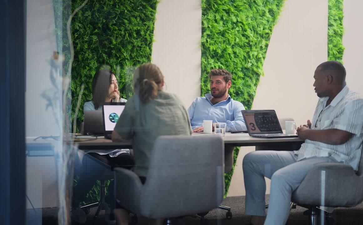 Maximus employees sitting a table.