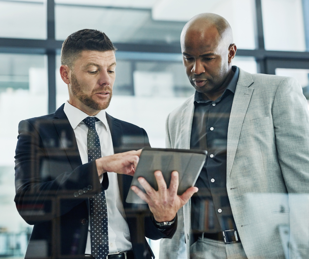 Two businessmen looking at a tablet